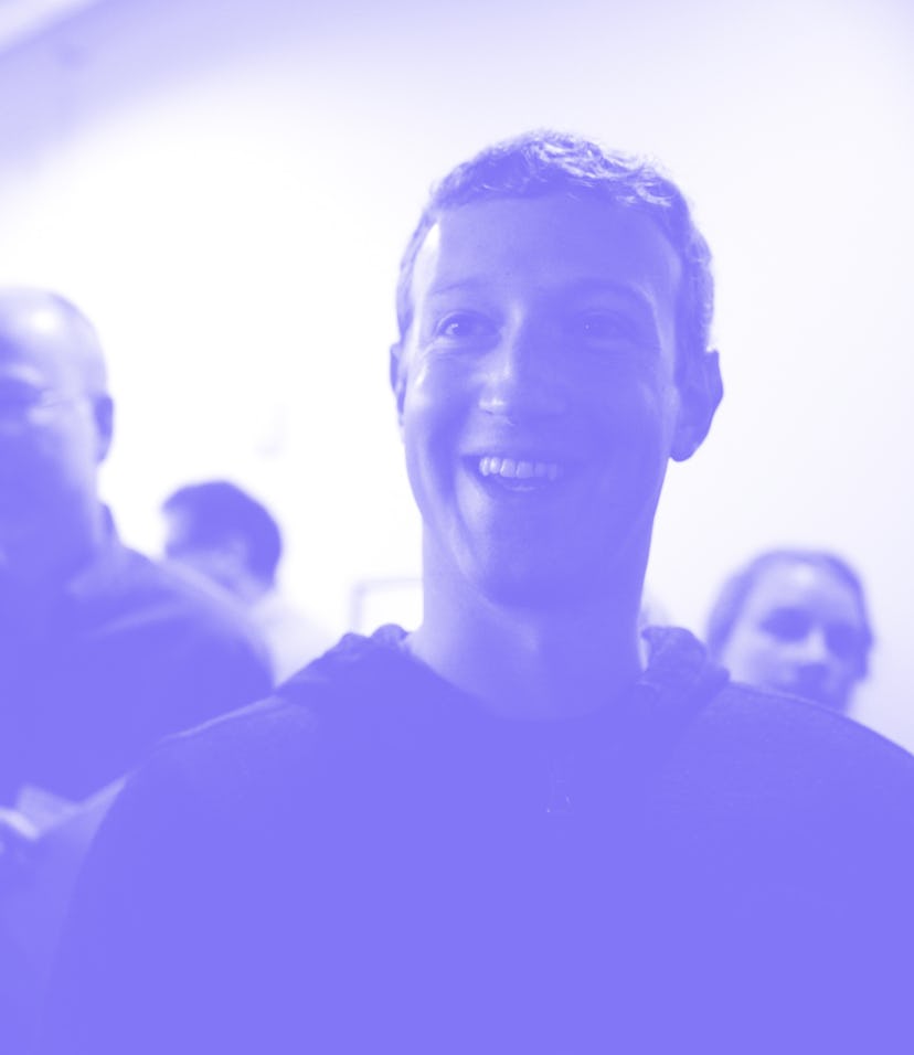 Mark Zuckerberg (center) speaks to a media after a press conference where a redesign of Facebook's ...