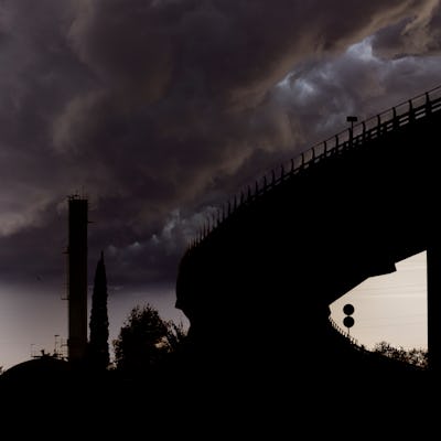 Elevated bridge in an industrial area with chemical factory chimneys