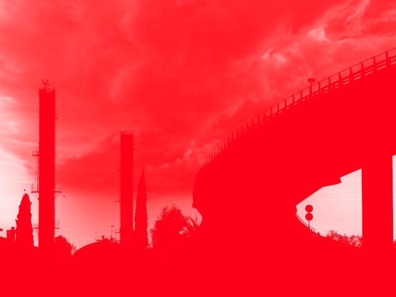 Elevated bridge in an industrial area with chemical factory chimneys