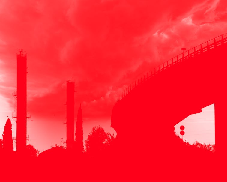 Elevated bridge in an industrial area with chemical factory chimneys