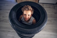 Teenage boys playing hide and seek in new tires in the hall.
Canon R5