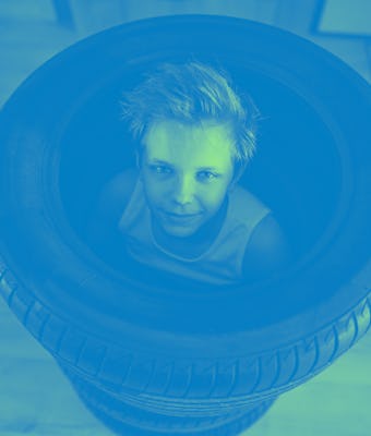 Teenage boys playing hide and seek in new tires in the hall.
Canon R5