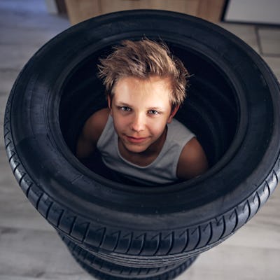 Teenage boys playing hide and seek in new tires in the hall.
Canon R5