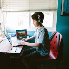A boy playing video games on discord in his room 