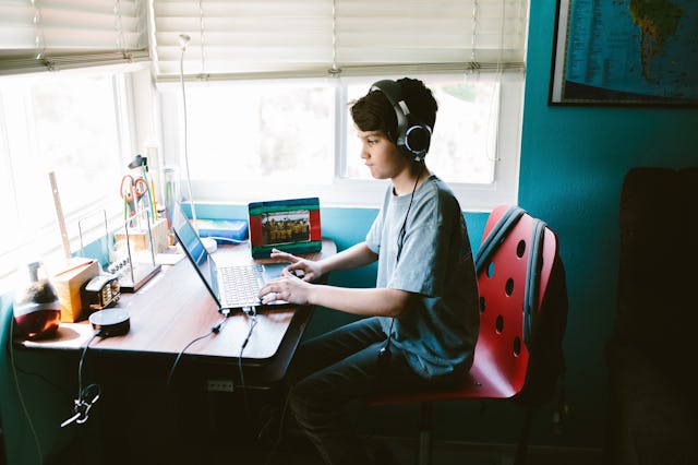 A boy playing video games on discord in his room