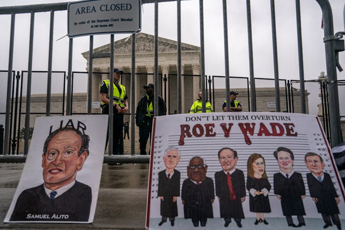 WASHINGTON, DC - JUNE 23:  Capitol Police watch an abortion-rights rally from behind the security fe...