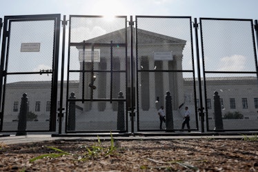 WASHINGTON, DC - JUNE 23: The U.S. Supreme Court Building is seen through a temporary security fence...