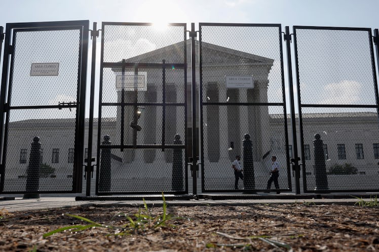 WASHINGTON, DC - JUNE 23: The U.S. Supreme Court Building is seen through a temporary security fence...