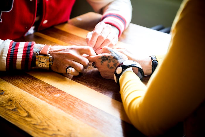 couple holding hands, how to talk about emotional labor with your partner