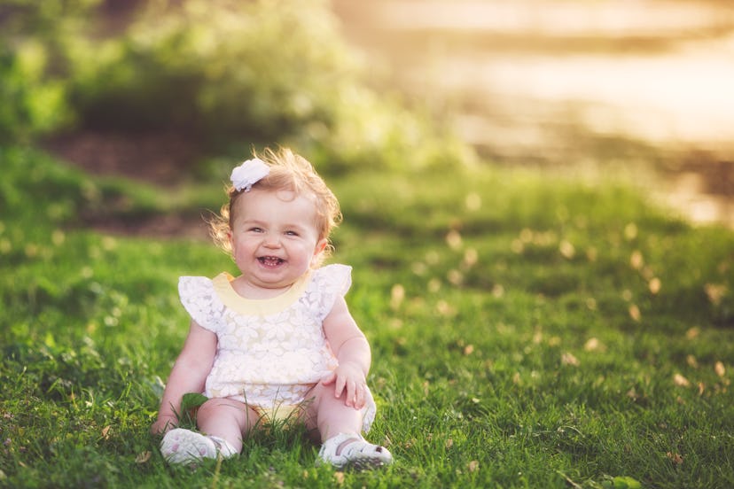 One year old baby girl seated on grass, earthy girl names