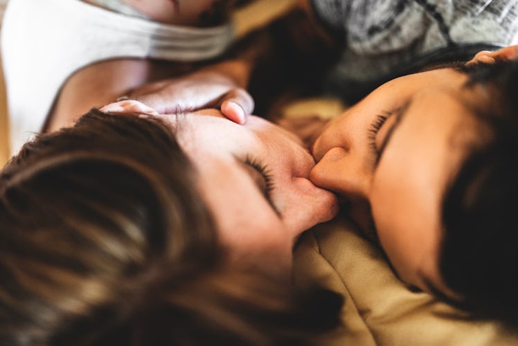 lesbian couple share the kiss on the bed
