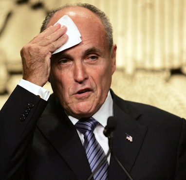 Former New York City Mayor Rudy Giuliani and 2008 presidential candidate wipes sweat from his brow d...