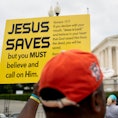A person holds a Jesus Saves sign outside the US Supreme Court in Washington, DC, on June 27, 2022. ...