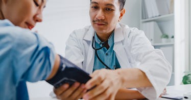 Doctor measuring patient's blood pressure.