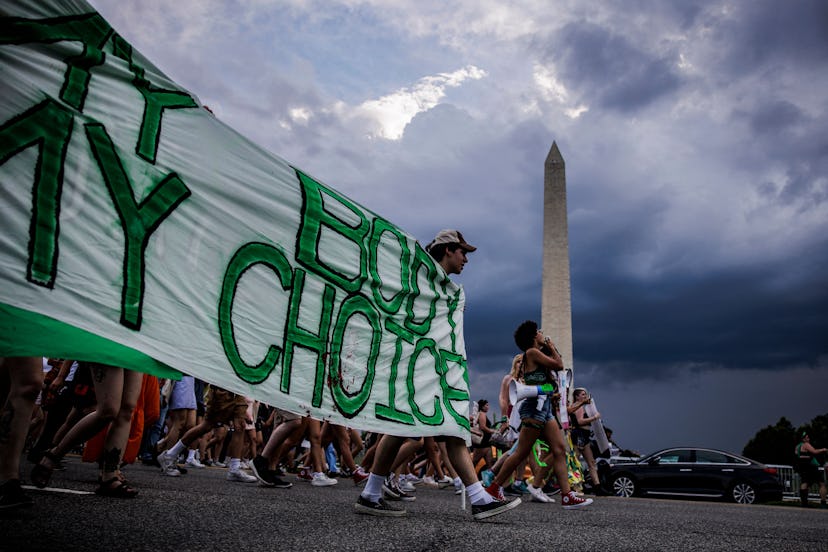 Abortion rights activists march past the Washington Monument as they protest in Washington, DC, on J...
