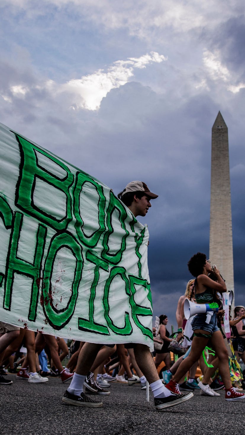 Abortion rights activists march past the Washington Monument as they protest in Washington, DC, on J...