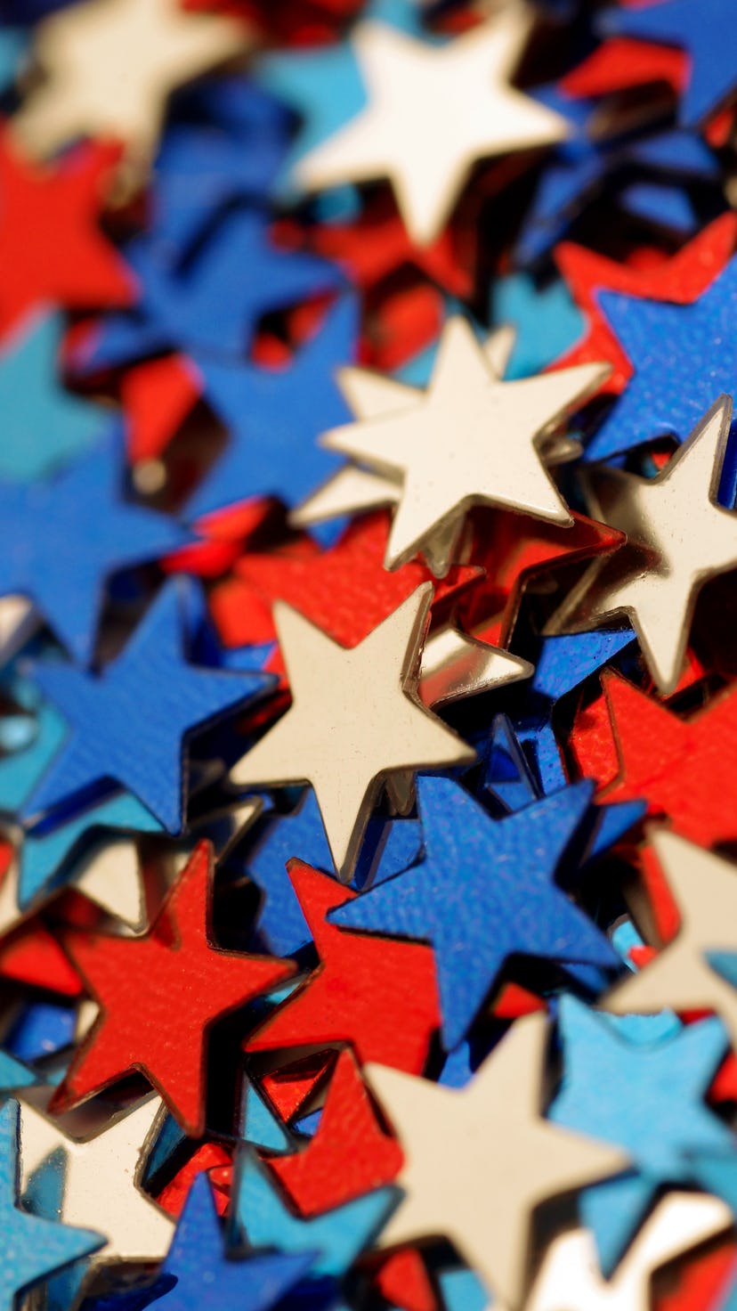 Macro shot of red, white, and blue star-shaped glitter/confetti.