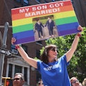 NEW YORK, NEW YORK - JUNE 26: Angela Ghiozzi holds up a sign as she watches the New York City Pride ...