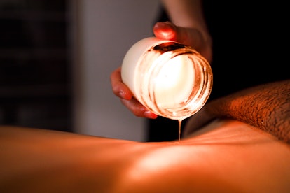 using a massage candle during kinky play 