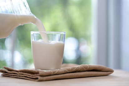 Milk from jug pouring into glass,milk