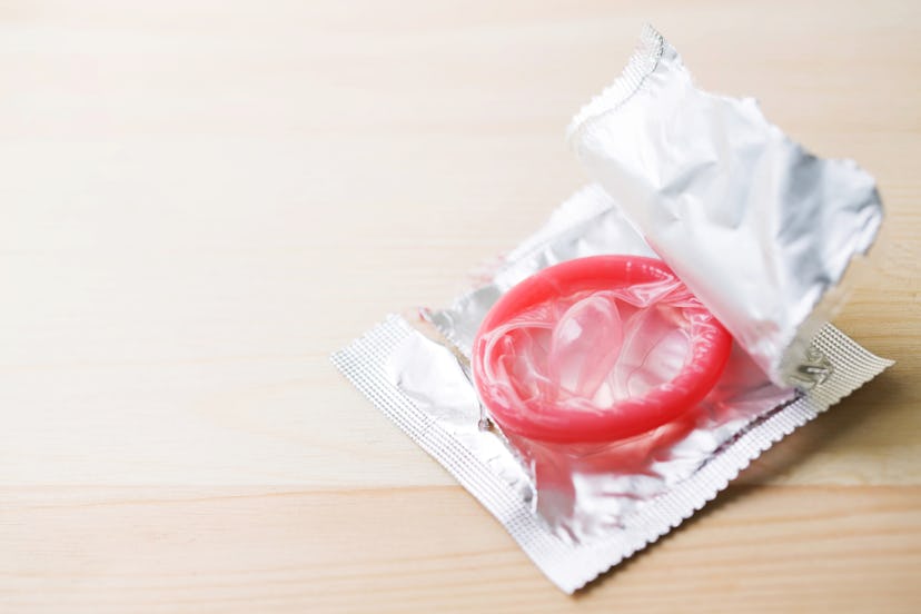 Red condom ready for use