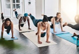 Full length shot of a group of pregnant women doing pilates together in studio in an article about i...