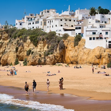Holidaymakers at Praia dos Pescadores beach in the municipality of Albufeira. Albufeira is a city an...