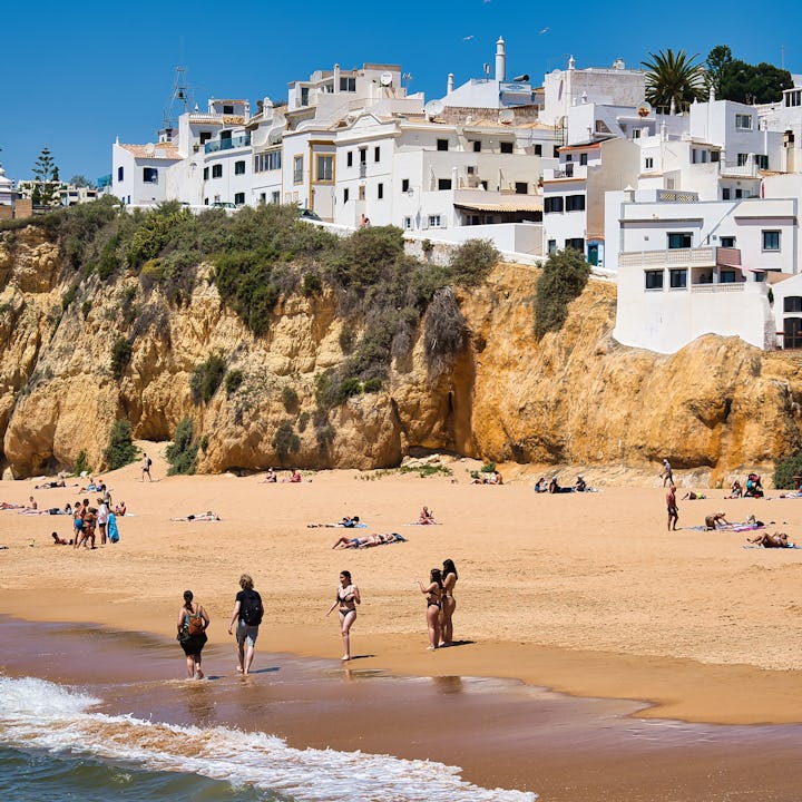 Holidaymakers at Praia dos Pescadores beach in the municipality of Albufeira. Albufeira is a city an...