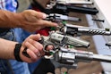 Attendees hold Ruger revolver pistols during the National Rifle Association (NRA) Annual Meeting at ...