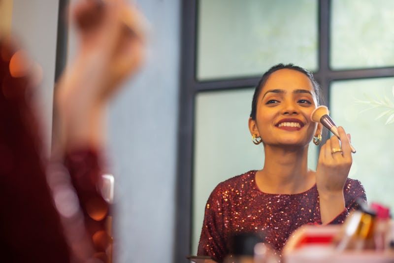 woman applying makeup