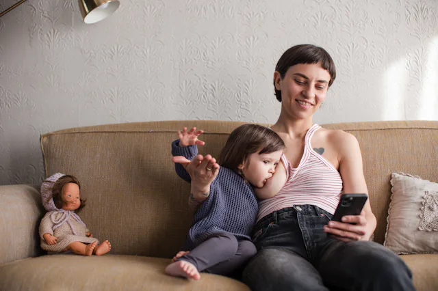 A mother breastfeeding a toddler. The AAP now recommends breastfeeding for two years or more.