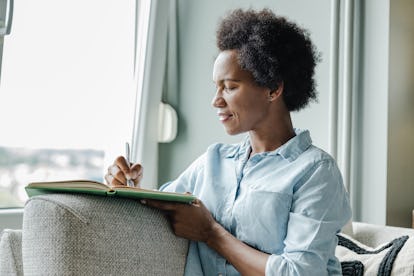 woman manifesting in journal 