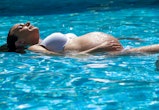 can you swim while pregnant? here's why experts say it's good for you