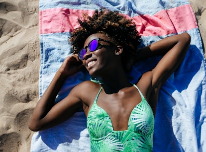 a woman wears a swimsuit from a Black-owned swimwear brand
