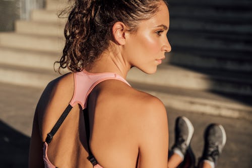 Fit woman in pink sportswear stretching after the workout. Here's your june 30 zodiac sign daily hor...