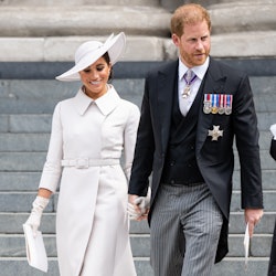 Meghan Markle, Duchess of Sussex and Prince Harry, Duke of Sussex hold hands at the platinum jubilee...
