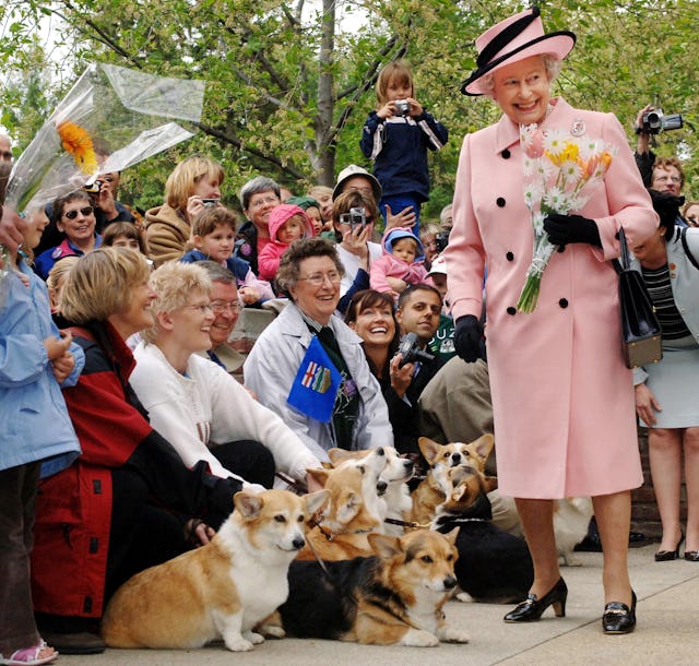 Britain's Queen Elizabeth II is greeted by local corgi enthusiasts as she departs the Legislature Bu...