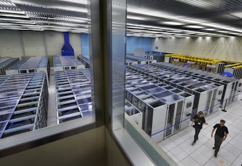 Scientists enter the main hall of the Large Laboratory of the European Organization for Nuclear Research (CERN)...