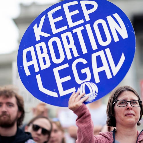 Kristi Engle Folchert of Denver, Colorado, holds a "Keep Abortion Legal" sign as she protests the ov...