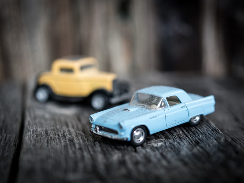 Toy vintage car on wooden background