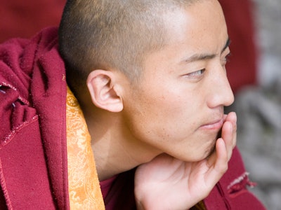 Monk thinking during theological discussion- Sera Monastery Lhasa Tibet. (Photo by: Planet One Image...
