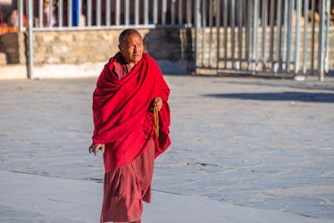 Tibetan man holding Buddhist Rosary in the complex of Perklor Monastery, Gyantse, Tibet, China - Oct...