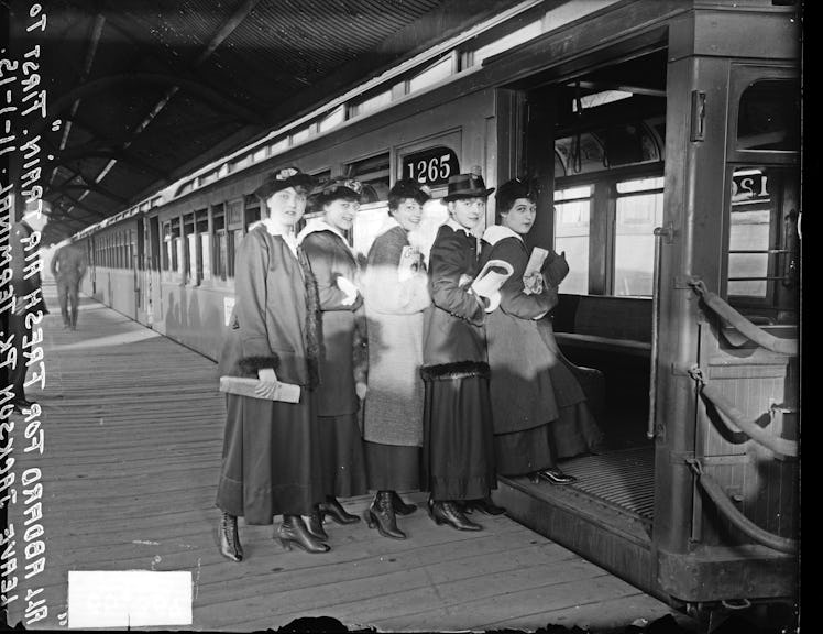 Five women getting on an open-air elevated train car, Chicago, Illinois, November 1, 1915. (Photo by...