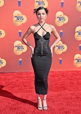 Olivia Rodrigo wearing a black corset dress and strappy sandals at the 2022 MTV Movie & TV Awards 