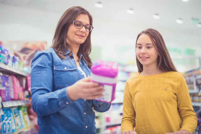 Photo of mother and daughter choosing sanitary pad