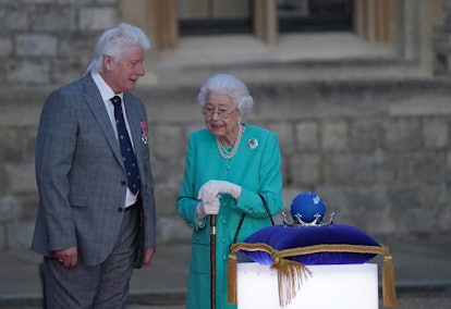 Britain's Queen Elizabeth II speaks to Bruno Peek, project chief at a ceremony to light of the Princ...