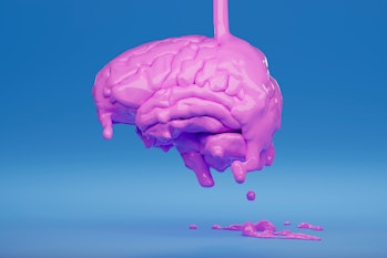 close-up of a pink brain with liquid pink paint pouring on it and dripping on a blue background ...