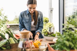 A woman cuts vegetables for salad. Here's your daily horoscope for june 7, 2022.