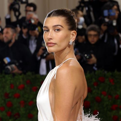 Hailey Bieber at the 2022 Met Gala wearing a backless dress. Stick-on bras can help you pull off loo...