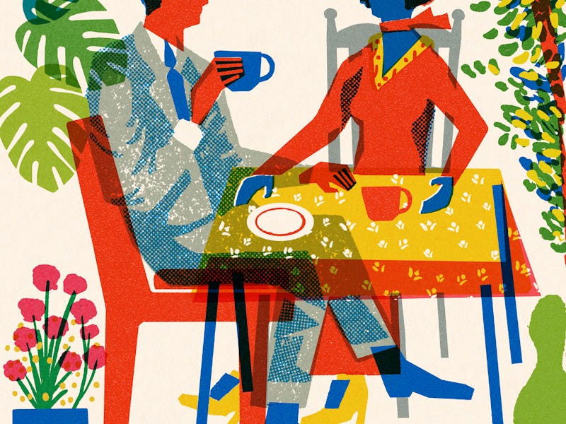 Two People Sitting at a Table Having Coffee